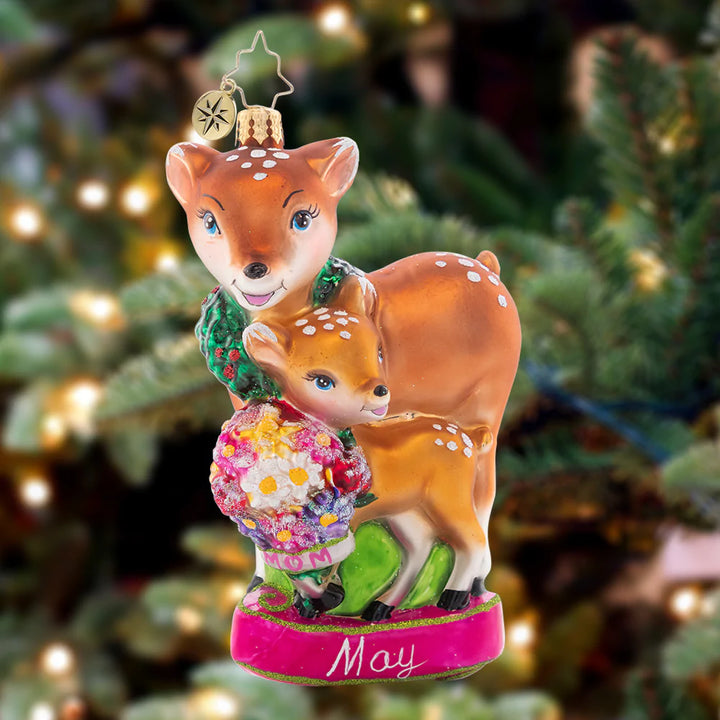 Ornament Description - Celebrate All Moms: This darling mama doe and her baby deer share a sweet moment, sniffing spring flowers together. The fifth piece in our Ornament of the Month collection is just as sweet as the mothers it honors!
