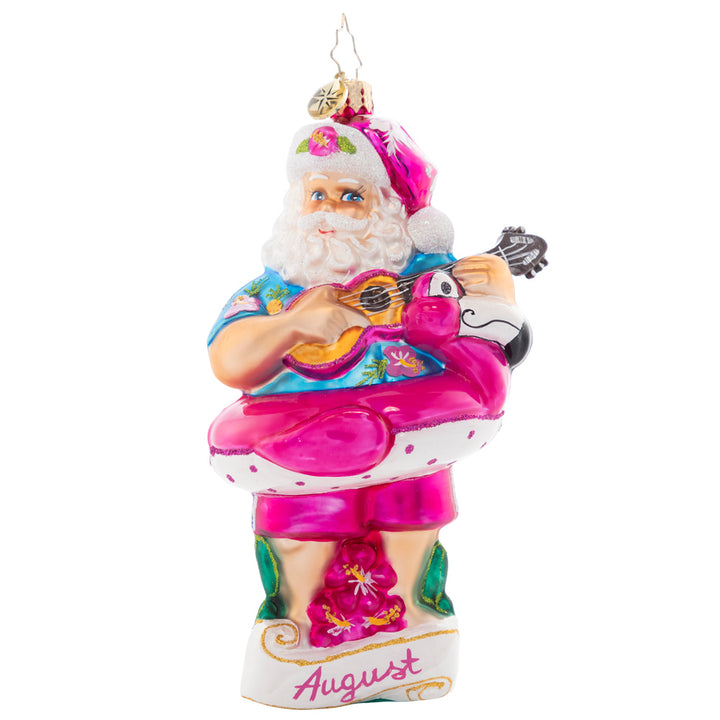 Front - Ornament Description - Beating the Heat: Santa is soaking up some summer sun, giving his ukulele a sound strum. As the eighth piece in our Ornament of the Month collection, he is here to savor summer.