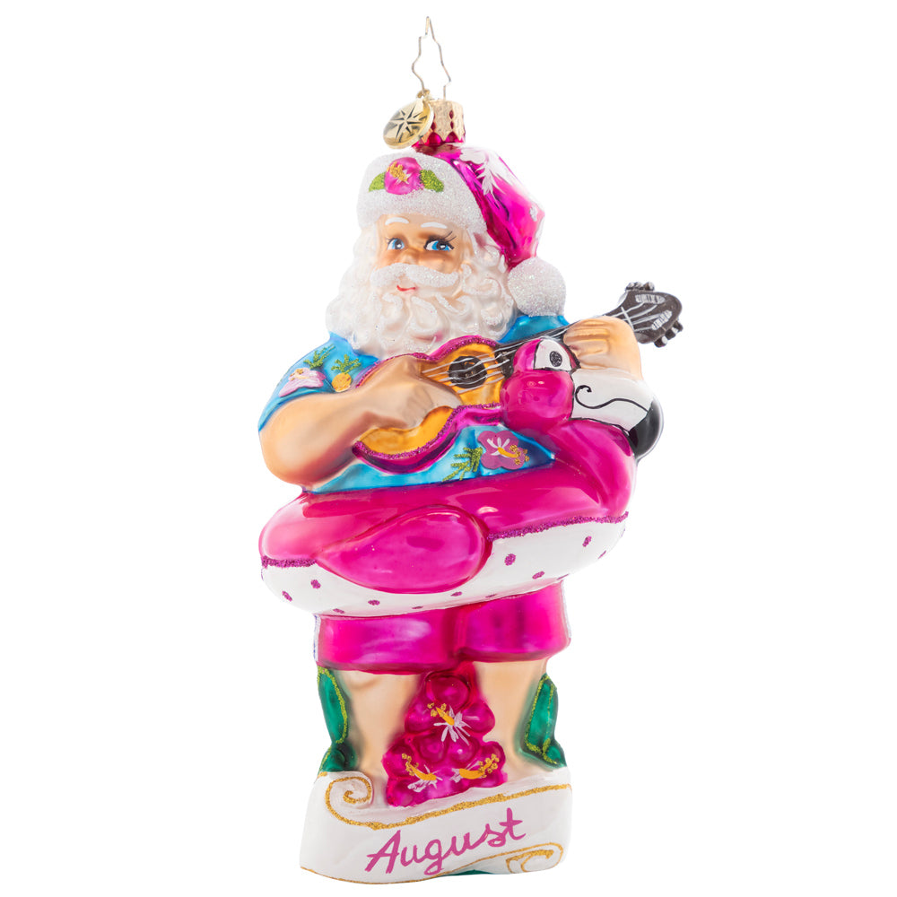 Front - Ornament Description - Beating the Heat: Santa is soaking up some summer sun, giving his ukulele a sound strum. As the eighth piece in our Ornament of the Month collection, he is here to savor summer.