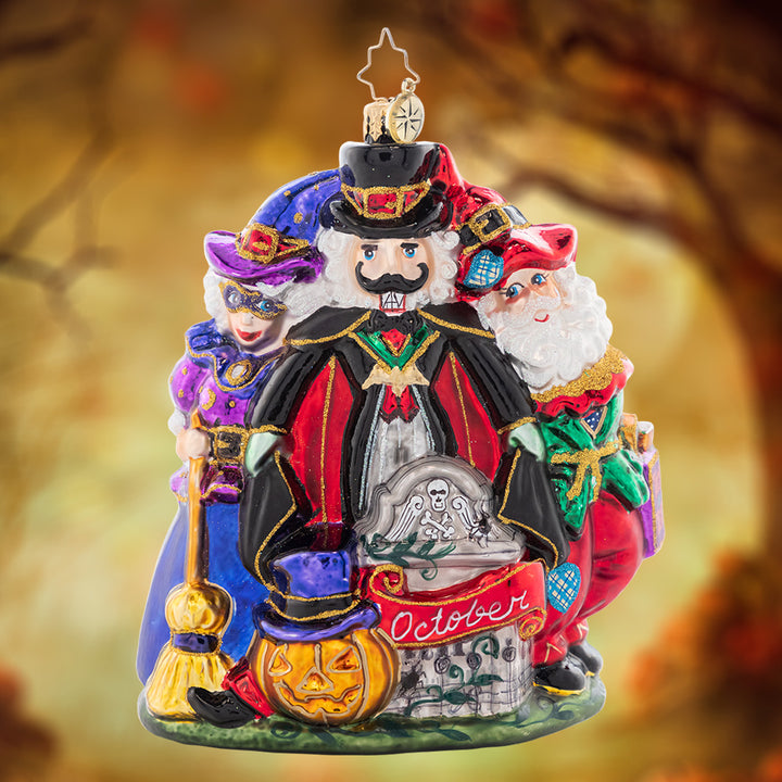 Ornament Description - Happy Hauntings: It's looking like a holiday-themed Halloween! Santa, Mrs. Claus, and a spooky nutcracker celebrate with fright and delight for the tenth piece in our Ornament of the Month collection.