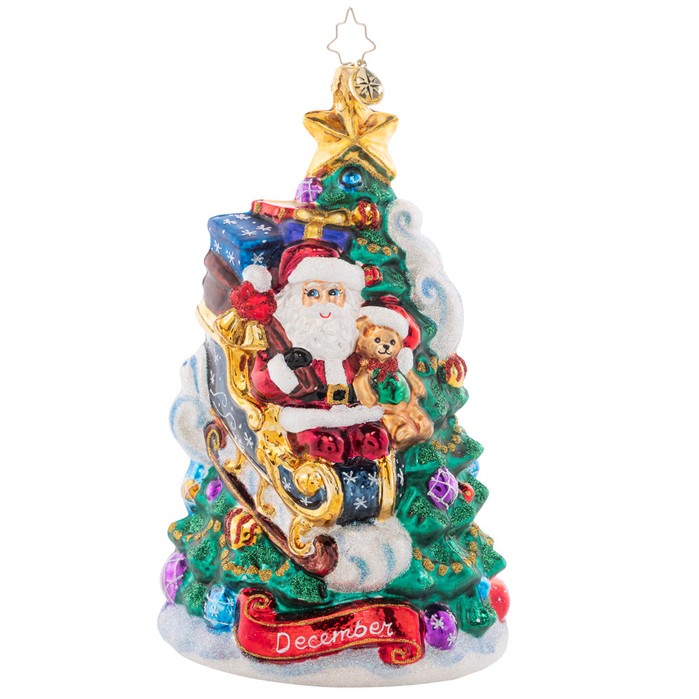 Front - Ornament Description - December Decadence: What a wonderous time of the year! Christmas is finally here, and Santa touches down on the trimmed tree to deliver presents just in time. The final piece of our Ornament of the Month collection celebrates the magic of Christmas!