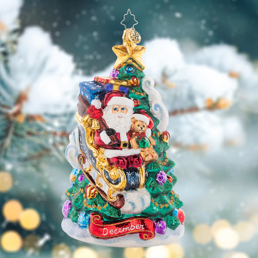 Ornament Description - December Decadence: What a wonderous time of the year! Christmas is finally here, and Santa touches down on the trimmed tree to deliver presents just in time. The final piece of our Ornament of the Month collection celebrates the magic of Christmas!