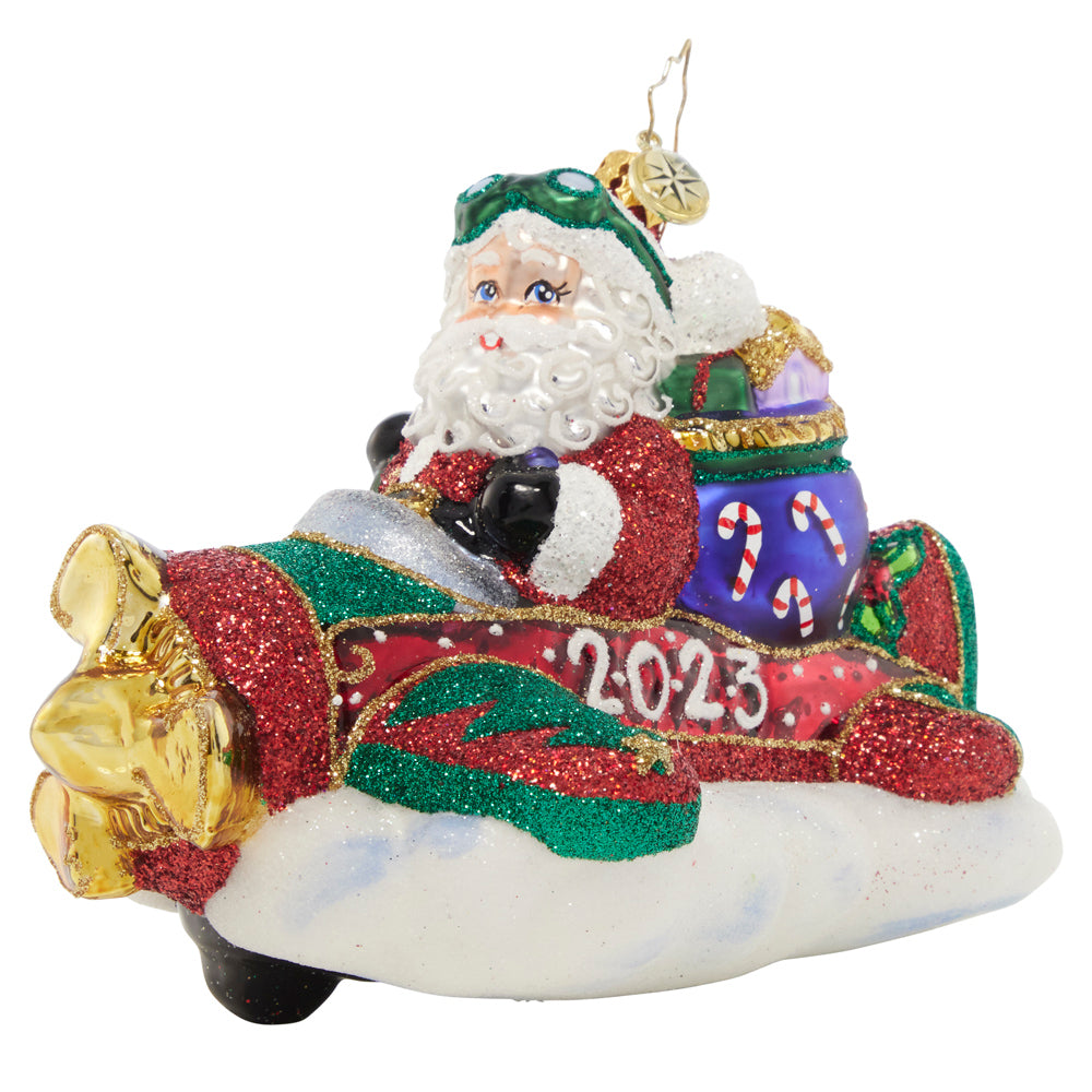 Ornament Description - This Year is Flying By: Santa is taking to the skies in a different type of ride for the New Year…he's switching out his signature sleigh for a one-man plane!