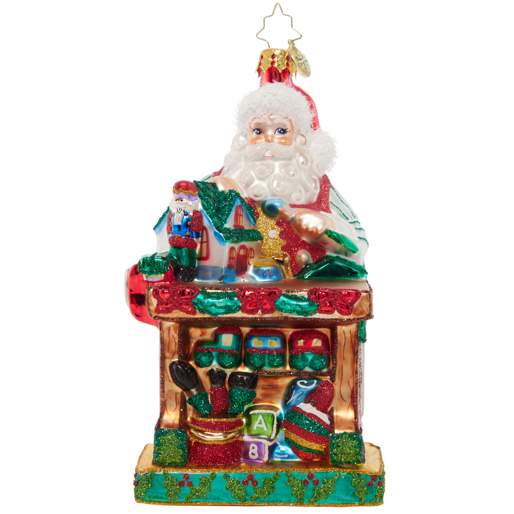 Ornament Description - Working Overtime: Santa is putting in extra hours in his North Pole workshop to make sure every toy is in tip-top shape. He's crafting Christmas joy with each piece he builds!