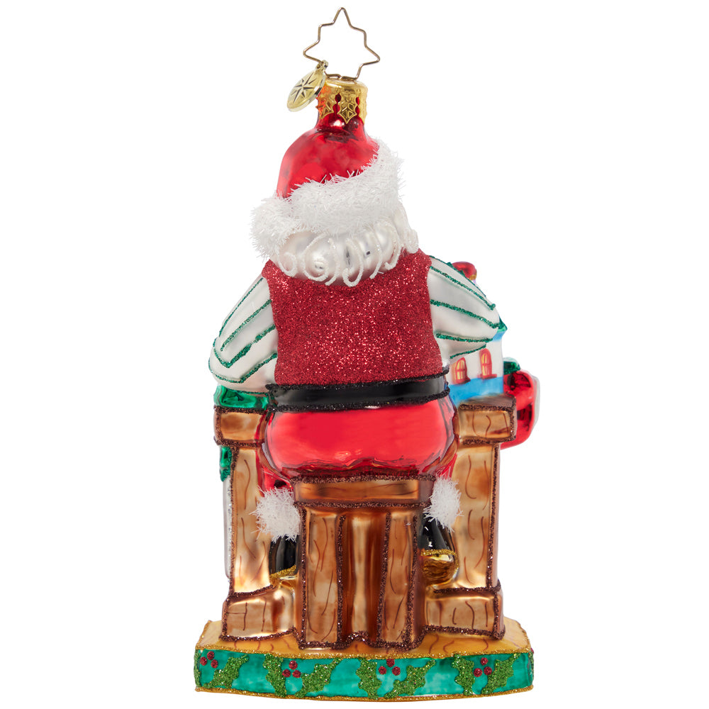 Back - Ornament Description - Working Overtime: Santa is putting in extra hours in his North Pole workshop to make sure every toy is in tip-top shape. He's crafting Christmas joy with each piece he builds!