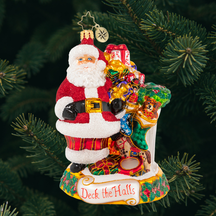 Ornament Description - Masterpiece By The Mantle: The stockings were hung by the chimney with care, in hopes that Saint Nicholas soon would be there--and here he is! Santa takes care to fill each stocking with toys and treats to surprise and delight on Christmas morning.