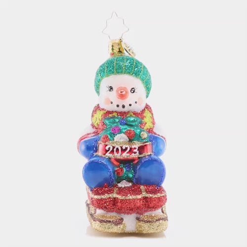 Video - Ornament Description - Sliding Through the Year: This little snowman is riding his toboggan sled into the Christmas season, looking forward to more winter fun before the holidays are all done! This video shows the ornament spinning slowly. 
