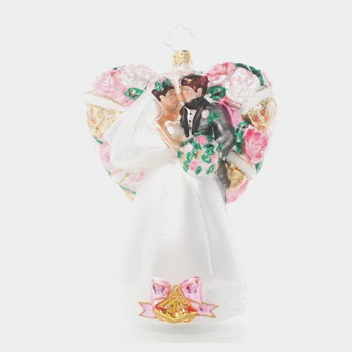 Video - Ornament Description - Love is in The Air: Just married! Honor the newlyweds in your life with this delightful heart-shaped ornament that celebrates new love. This video shows the ornament spinning slowly. 