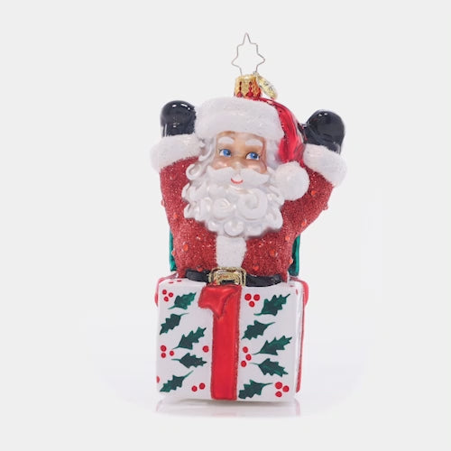 Video - Ornament Description - Santa-In-The-Box: Pop-goes-the-Santa! This jolly fellow is the most wonderful Christmas surprise, popping out of a holly-decked gift box. This video shows the ornament spinning slowly. 