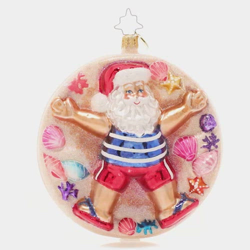 Video - Ornament Description - Beach Cherub Claus: Santa has traded snow angels for sand angels! He's embracing his inner beach bum on a sunny vacation at the beach.