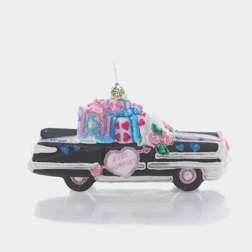 Video - Ornament Description - Wedding Day Getaway: Now that's what I call a getaway car! Send the newlyweds off in style in this classic cruiser decorated with wedding florals and filled with wedding gifts. This video shows the ornament spinning slowly. 