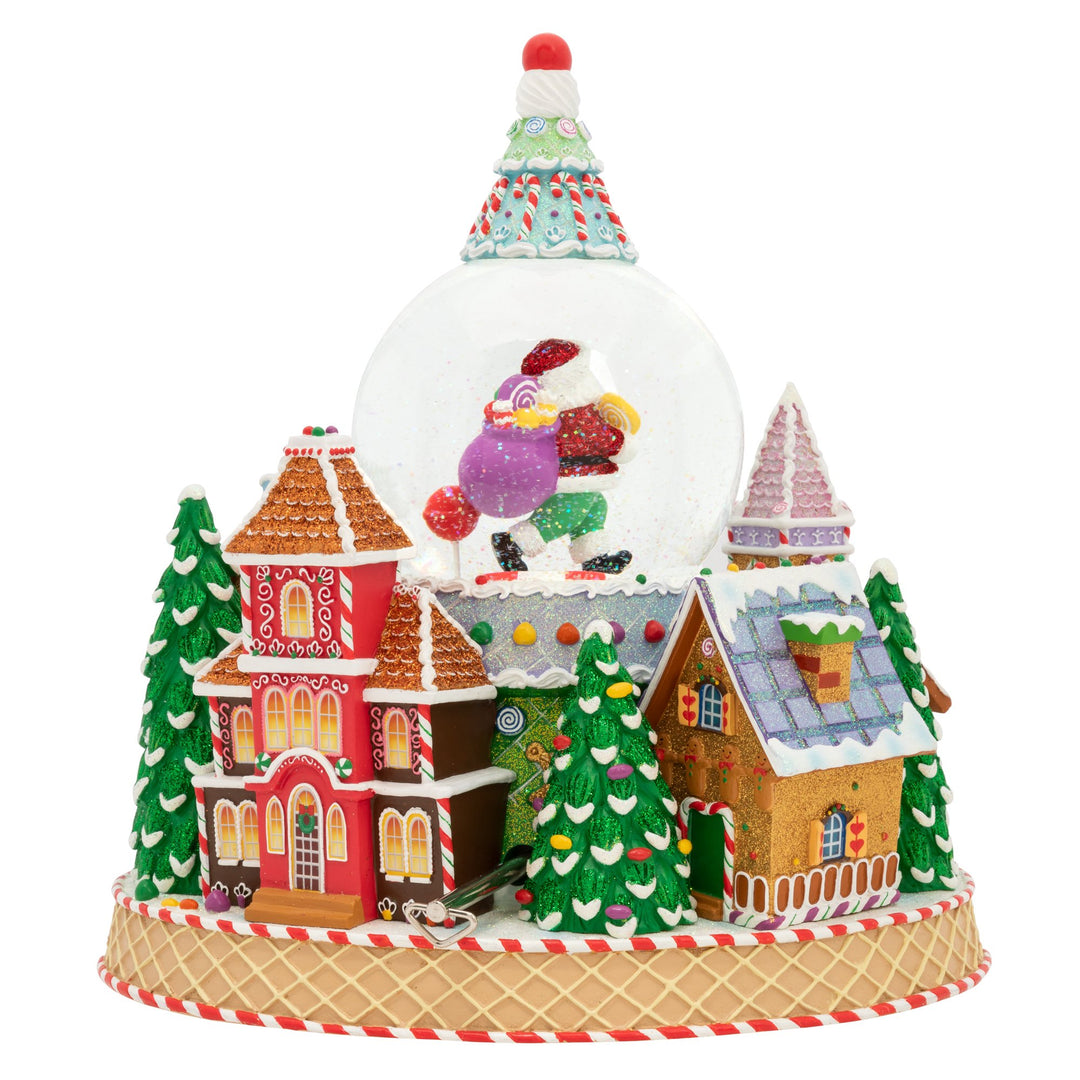 Back - SnowGlobe Description - Ginger Village Delight: From the roof, to the entryway, and all the way down to the door knockersâ€”everything in this ginger village is made entirely of candy! The prospect of staying in this ultra-sweet land forever sounds downright dandy. Celebrate the sweet side of the holidays with this mouthwatering snowglobe. It even plays the classic Christmas tune, "Toyland" and blows snow!