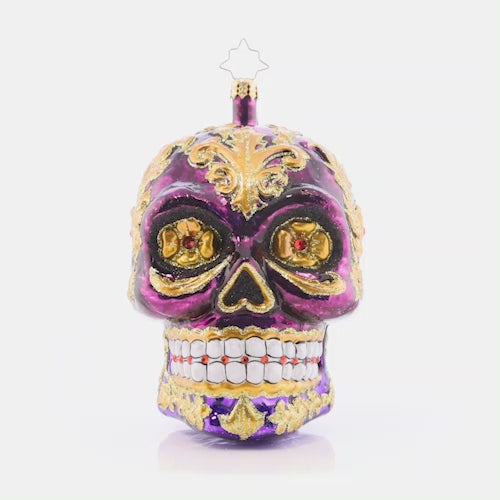 Video - Ornament Description - Festive Filigree Calavera: Looking fancy as ever with glowing golden eyes and stunning glittered swirls, this Calavera ornament is a frightfully festive piece to feature on your tree.