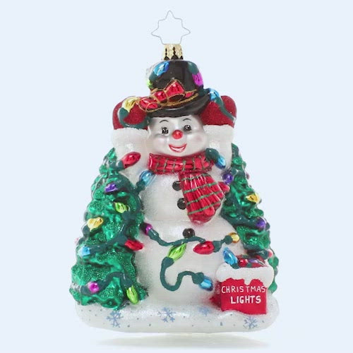 Video - Ornament Description - Let There Be Lights: This frosty snowman has been wrestling with his Christmas lights all day long, and he's at last down to hanging his final strand. He's glad you're here to admire his holiday handiwork! This video shows the ornament slowly spinning. 