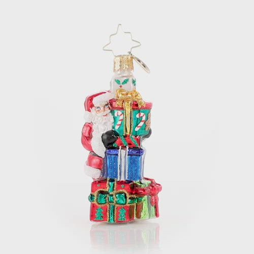 Video - Ornament Description - A Tower of Tidings Gem: Santa sure has his hands full with all these gifts! Luckily after centuries of juggling Christmas responsibilities, he has become an expert at balance! 