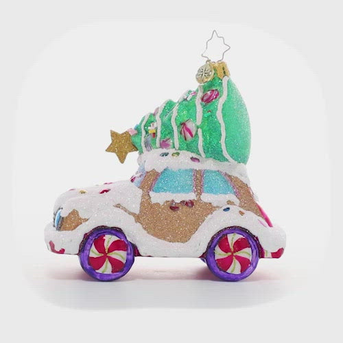 Video - Ornament Description - Candy Tree Delivery: Over the river and through the woods…someone has driven this cookie car far and wide to find the perfect candy Christmas tree! It looks like they picked one that will be just right to brighten up their cozy gingerbread house.