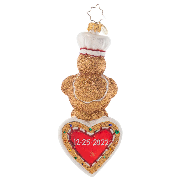 Back - Ornament Description - Sweet Heart Baker: Let this cuddly gingerbread fellow send your own personal greetings to friends and family! He'll make a wonderful impression with his ear-to-ear grin and a colorful cake baked with love. Note: Please allow approximately one month (on top of shipping time) for our elves to personalize your ornament.