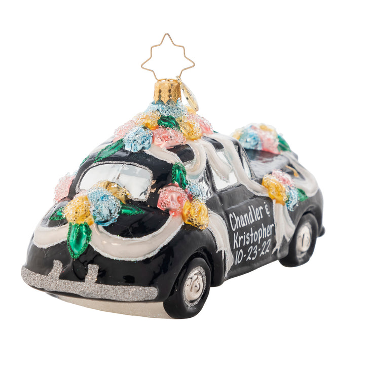 Back Side View - Ornament Description - Heading to the Chapel: Dashing to their romantic honeymoon hideaway, the couple within this ritzy racer clearly have an eye for the elite. Add the names of the newest couple in your life to the doors of this vintage vehicle. It will make a one of a kind gift to commemorate a wonderful occasion. Note: Please allow approximately one month (on top of shipping time) for our elves to personalize your ornament.