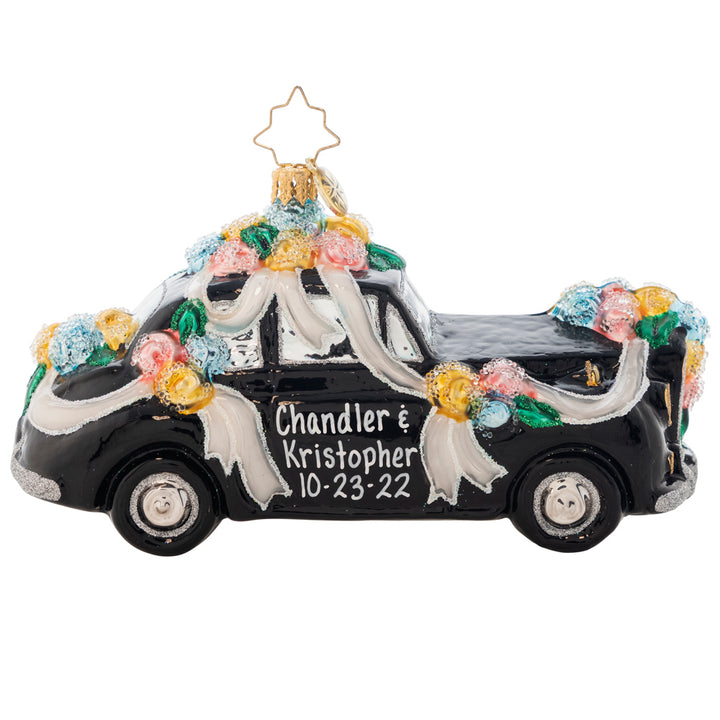 Ornament Description - Heading to the Chapel: Dashing to their romantic honeymoon hideaway, the couple within this ritzy racer clearly have an eye for the elite. Add the names of the newest couple in your life to the doors of this vintage vehicle. It will make a one of a kind gift to commemorate a wonderful occasion. Note: Please allow approximately one month (on top of shipping time) for our elves to personalize your ornament.
