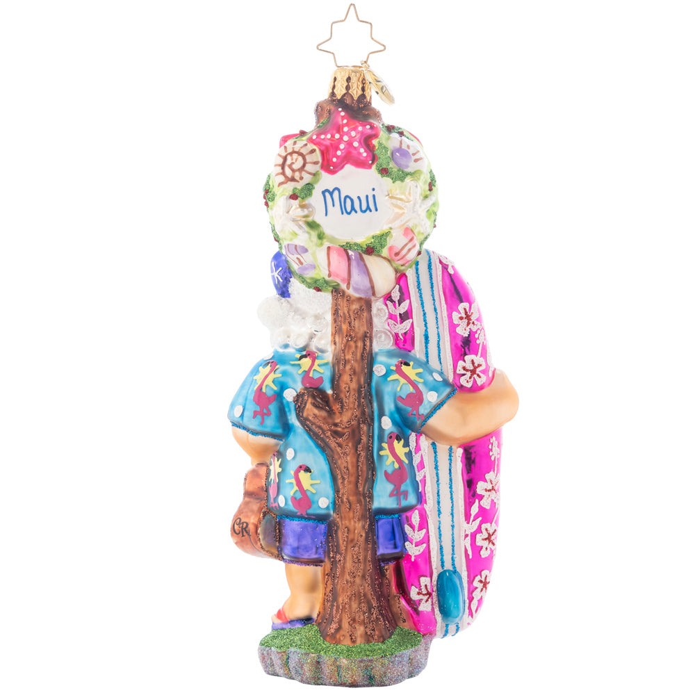 Back - Ornament Description - Aloha Santa!: Flamingo pink is a new color theme for Santa! Bring the tropics to your tree with this ukulele playing, pink surfboard riding, ocean themed, Hawaiian vacation mode St. Nick! Note: Please allow approximately one month (on top of shipping time) for our elves to personalize your ornament.