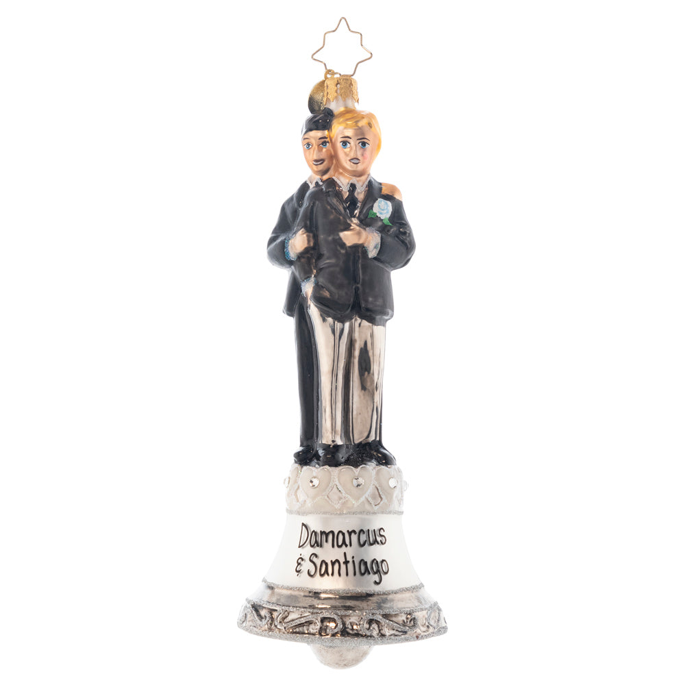 Ornament Description - Dedicated Devotion: These two gentlemen are dedicated to each other and ready to start the first day of the rest of their lives! Ring the bell, celebrating this loving couple and sending them on their new path together! Note: Please allow approximately one month (on top of shipping time) for our elves to personalize your ornament.