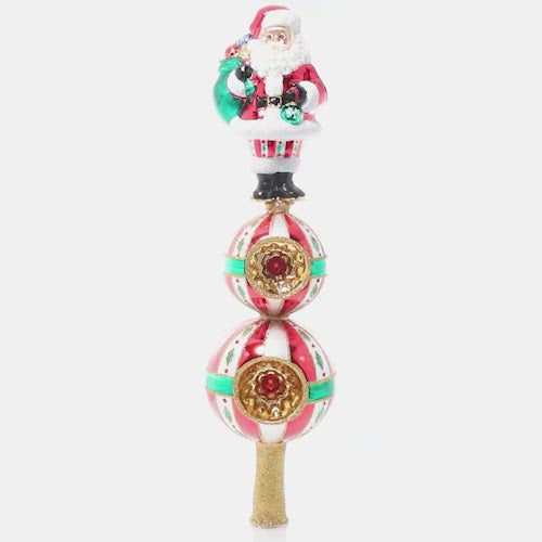 Video - Finial Description - Christmas Classics Finial: Top the tree with good cheer with this Santa finial inspired by classic Christmas tradition. Standing tall above two golden starbursts, Santa is the perfect finishing touch to your tree!