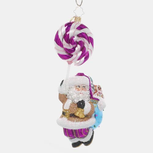 Video - Ornament Description - Lolli Jolly Christmas: May your holiday be extra sweet this year! Santa dangles from a twirly, swirly purple lollipop on his way to deliver a sack full of goodies. This video shows the ornament slowly spinning. 