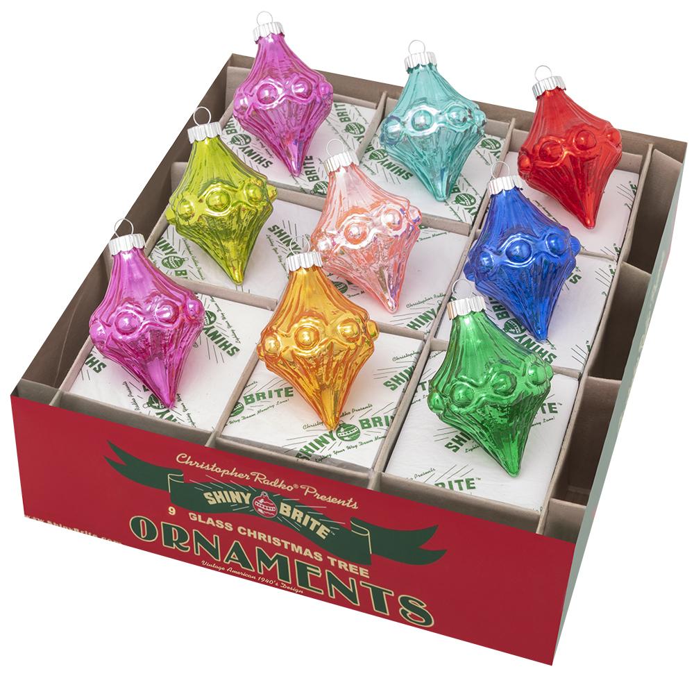 Ornaments - Description: Christmas Confetti 9 Count 2.5" Shapes - Add dimension and dazzle to your tree with this nine-count set of diamond-shaped glass ornaments. With shapes and a color palatte inspired by your favorite vintage Christmas ornaments, this set will be right at home with the rest of your treasured collection.