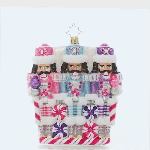 Video - Ornament Description - The Sweetest Trio: A trio of nutcrackers smile dutifully from their posts, dressed in uniforms of wintry pastels. Someone's got to guard the North Pole candy stash, and three heads are better than one! This video shows the ornament spinning slowly. 