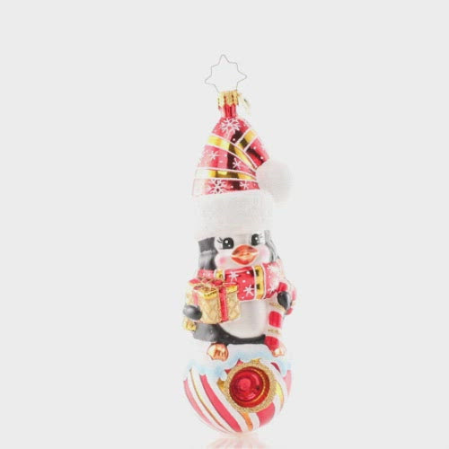 Video - Ornament Description - Play it Cool: This tiny penguin friend smiles from her perch atop a peppermint candy ball in a swirly Santa hat and matching scarf. She's looking minty, merry and marvelous! This video shows the ornament spinning slowly. 