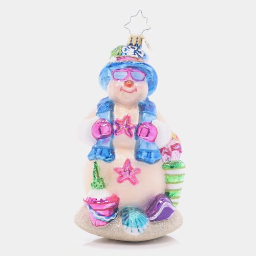 Video - Ornament Description - Beach Day Snow Friend: Basking in the sunshine, this sand-colored Snowman is happy to have a break from the cold winter weather! He's ready for the perfect beach day with a pail and shovel for sandcastle building.