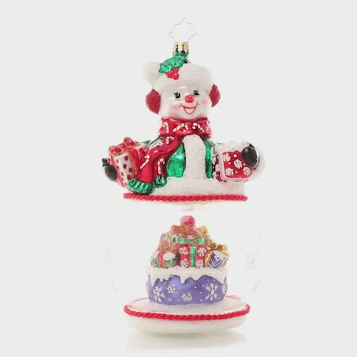 Video - Ornament Description - Chilly and Cheery: This jolly snowman is ready for Christmas! As he proudly shows off his lovingly-wrapped packages, we see there's more where that came from inside his snow globe base!