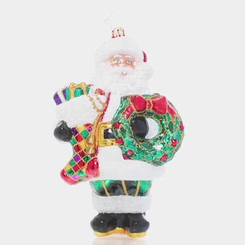 Video - Ornament Description - Christmas Splendor Claus: Fa-la-la-la-la! Armed with a holiday wreath to hang and a Christmas stocking already stuffed full of surprises, Santa is ready to deck the halls.