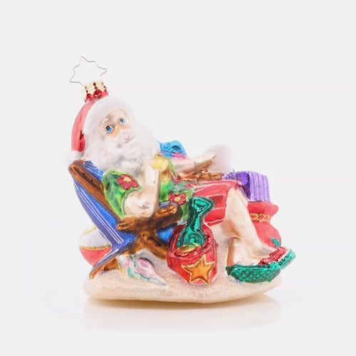 Video - Ornament Description - Beach Bum Santa: Santa is kicking his feet up and watching the waves for a post-holiday vacay. The North Pole is pretty chilly this time of year, so he's excited for surf and sun with a little Christmas fun!