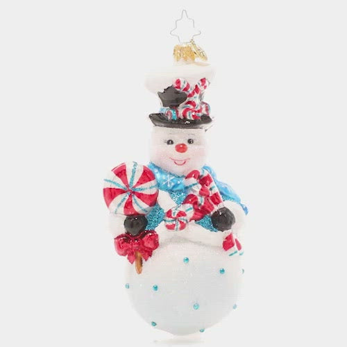 Video - Ornament Description - Minty Magic Snowman: Make this holiday season extra sweet with this whimsical treat-toting snowman! His rosy cheeks suggest he's been playing in the snow all day, so he's ready to wind down with his favorite sweet snacks! This video shows the ornament spinning slowly. 