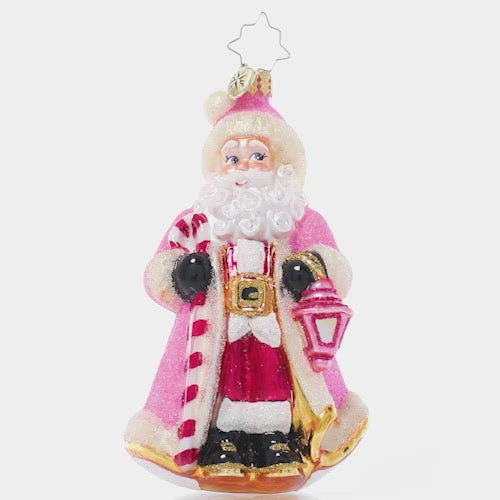 Video - Ornament Description - Donned in Pink: Cloaked in sparkling pink from head to toe, this Santa looks as sweet as sugar as he lights the way through a snowy winter's night. This video shows the ornament slowly spinning
