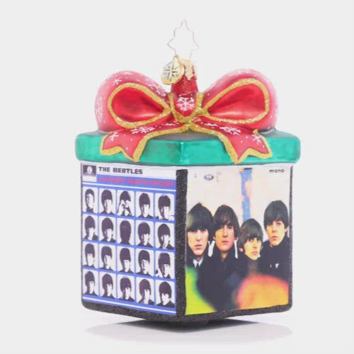 Video - Ornament Description - Boxed Up Bundles: Tied up with a sparkling bow, this miniature gift box highlights four of The Beatles' iconic albums. Let this piece inspire you to play one as you decorate your tree!