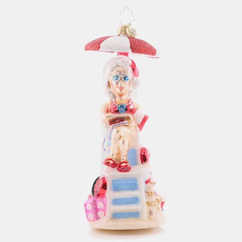 Video - Ornament Description - Lovely Lifeguard: Staying cool under a parasol in her stylish shades, Mrs. Claus is keeping a close eye on the crashing waves. This video shows the ornament slowly spinning.