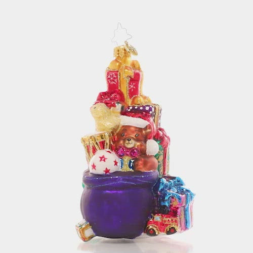 Video - Ornament Description - Stacked Up Surprises: Someone has been extra good this year! This towering pile of colorful presents is full of surprises for lucky little girls and boys. This video shows the ornament spinning slowly. 