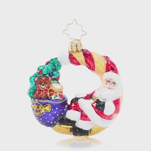 Video - Ornament Description - Over the Moon For Christmas Gem: Even Santa needs a break sometimes! He sets down his sack to lounge against a crescent moon to look down on the peaceful sleeping world and reflect on his hard work so far. This video shows the ornament spinning slowly. 