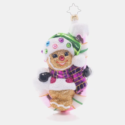Video - Ornament Description - Candy Cane Cutie: Hang in there, buddy! A curvy candy cane is the perfect perch for this pint-sized gingerbread cookie.