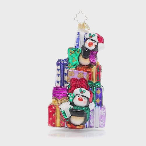 Video - Ornament Description - Santa's Little Helpers: A team of tiny penguin pals are giving the elves a day off, pitching in to help Santa stack the last of his present pile in preparation for Christmas Eve. This video shows the ornament spinning slowly. 