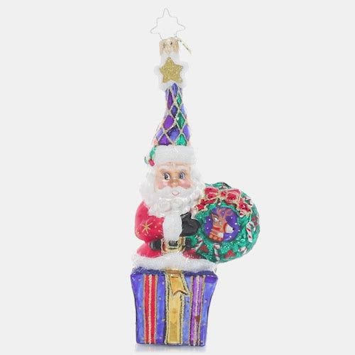 Video - Ornament Description - Marry & Bright Santa: Outfitted in cheery Christmas colors, this Santa is dressed to celebrate the season. He's holding hope for a wonderful holiday and a peaceful new year for us all! This video shows the ornament spinning slowly. 
