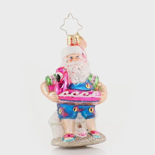 Video - Ornament Description - Out of Office Santa Gem: After his jam-packed holiday season, Santa is relaxing on a well-deserved vacation! He has traded his fur suit for swim shorts and his sack for a flamingo floatie-- he is looking ready for some off-duty fun in the sun! This video shows the ornament spinning slowly. 