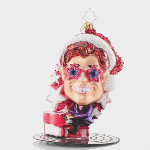 Video - Ornament Description - Elton John's Center Stage: Donning a Santa hat and his signature shades, Elton John takes center stage for a holiday concert of some of his greatest hits. He is ready to Step Into Christmas and will have the crowd Crocodile Rockin' in no time! The video shows this ornament slowly spinning. 