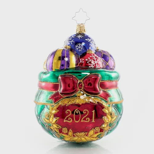 Video - Ornament Description - Cherished Keepsakes 2021: A look back at another year come and gone is much like sorting through this collection of treasured vintage heirloom baubles. As Santa selects a few to hang on this year's tree, he pulls each one out to recall the special memories they evoke, then carefully tucks it away for another year.