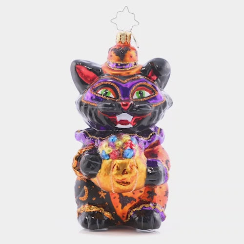 Video - Ornament Description - Dapper Black Cat: A little trick-or-treater in peak Halloween style with this fancy feline smile! This cat has a basket that is quite handy for filling it to the top with loads of candy! The video shows the ornament slowly spinning. 