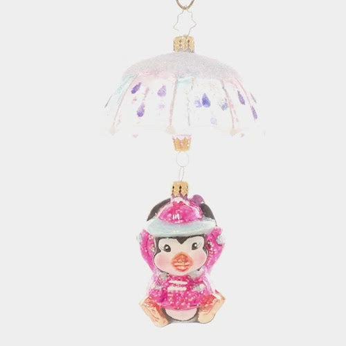Video - Ornament Description - When It Rains It Pours: Look out below! This adorable penguin pal is drifting in with the snowfall on a pastel parasol. This video shows the ornament spinning slowly. 