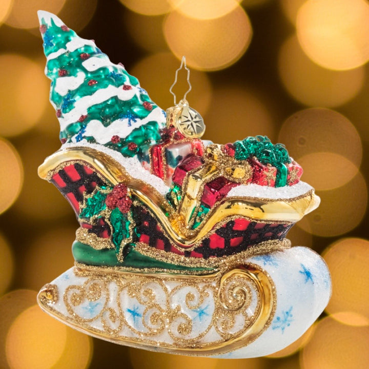 Ornament Description - Snowy Sleigh Ride: This delightful sleigh is packed to the gills with everything you need for a joyful Christmas, even the tree. 
