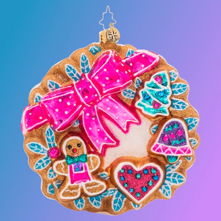 Ornament Description - Sweet Treats Wreath: A smiling gingerbread man and other holiday shapes shine from their place on this festive iced cookie wreath. What could be sweeter?